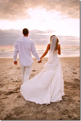 A bride and groom may choose to have a formal wedding at a beach setting or